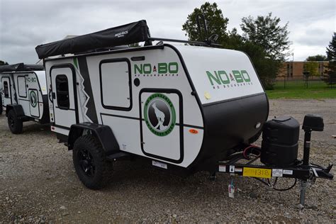 Nobo trailer - Under 25 feet in length, you will not be able to find a better suited toy hauler! Enjoy a true queen-sized bed, dry bath, and full kitchen up front, all while maximizing that 10 ½ feet of front-to-back garage area for your toys and your gear. Hitch Weight. 896 lb. 